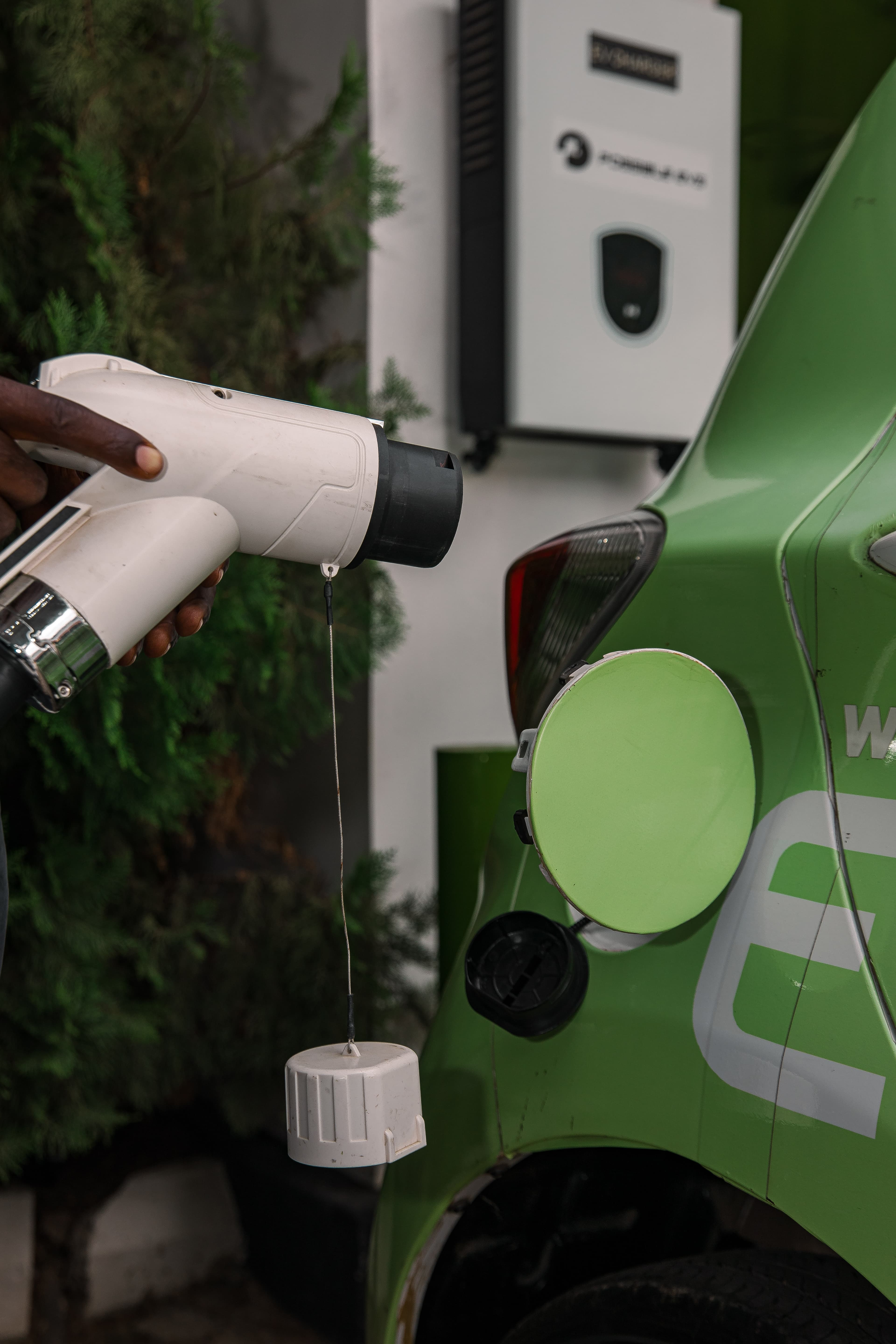 Possible EVS service technician inspecting an electric vehicle at the depot